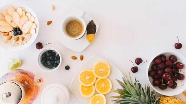 Café; harina de avena; Té y frutas sobre fondo blanco