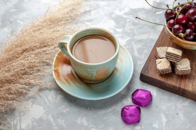 café con leche con caramelos, gofres y guindas a la luz