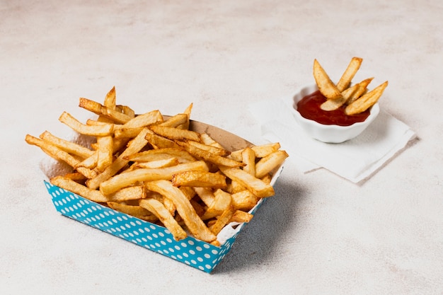 Caja azul de papas fritas con salsa de tomate