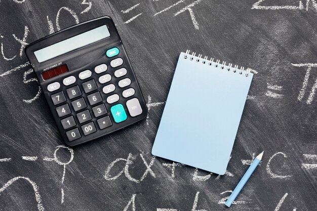 Calculadora y cuaderno en pizarra