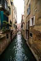 Foto gratuita calle del canal tradicional con góndola en la ciudad de venecia, italia