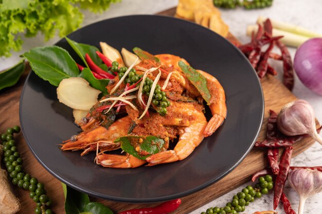 Camarones Chuchi en un plato con semillas de pimiento fresco