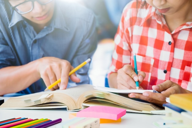 El campus de los estudiantes jóvenes ayuda al amigo a ponerse al día y aprender.