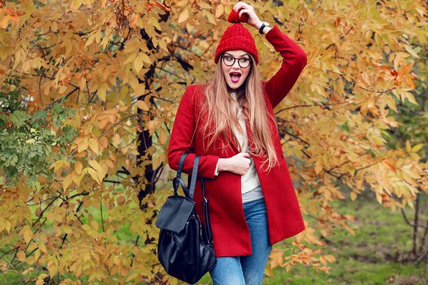 Cara sorprendida Parque de otoño Señora bastante joven caminando y disfrutando de la naturaleza.