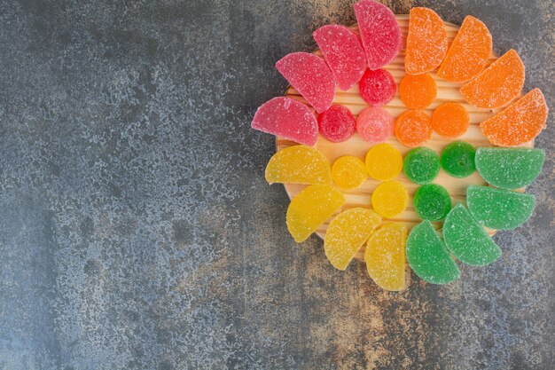 Caramelo dulce de gelatina de colores sobre fondo de mármol