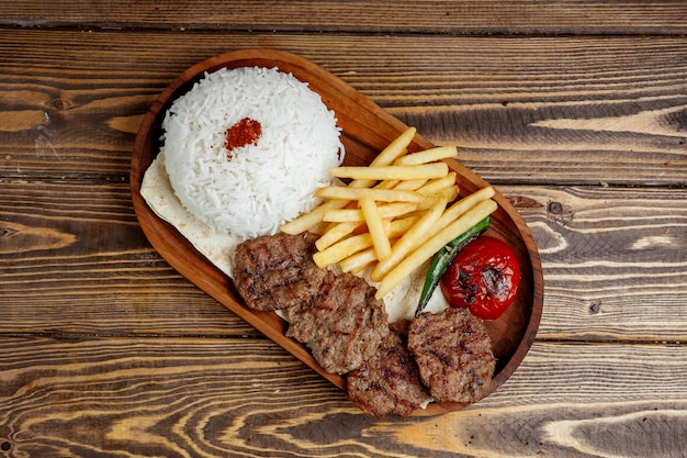 Carne frita con arroz y papas fritas