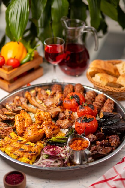 Carne de res, kebab de pollo, barbacoa con papas asadas, asadas, tomates y arroz.
