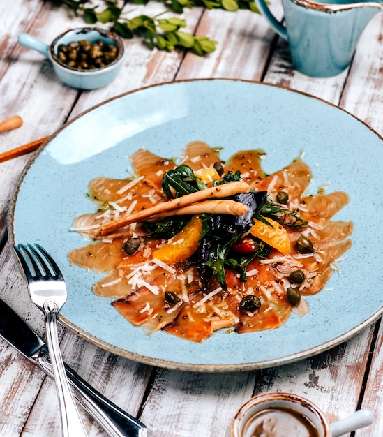 Carpaccio de salmón con verduras sobre la mesa