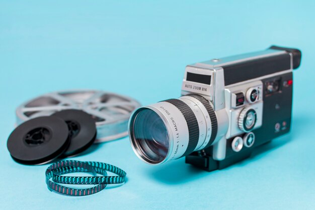 Carretes de película; Tiras de película y videocámara vintage sobre fondo azul
