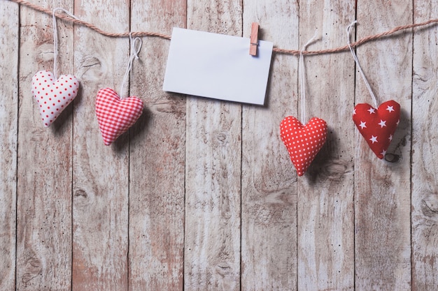 Carta colgando de una cuerda con corazones debajo