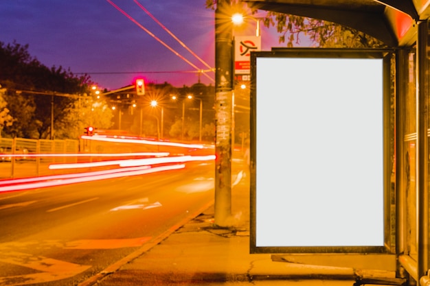 Cartelera en blanco en la parada de autobús en la noche