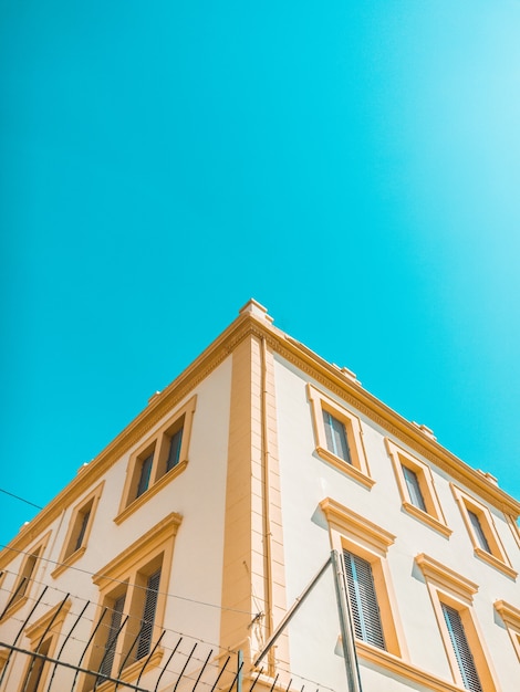 Casa de hormigón amarillo y marrón bajo un cielo despejado