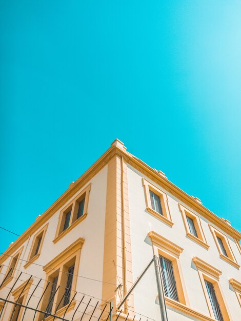 Casa de hormigón amarillo y marrón bajo un cielo despejado