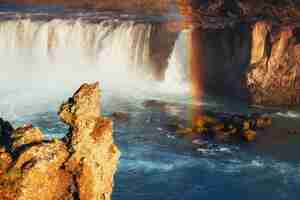 Foto gratuita cascada de godafoss al atardecer. fantástico arcoiris. islandia, europa