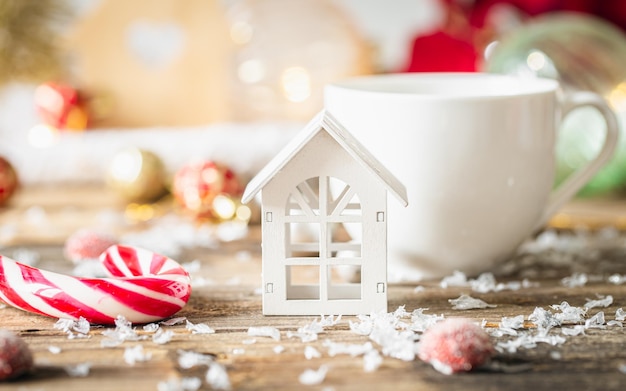 Foto gratuita una casita de madera y decoración navideña en una mesa de madera