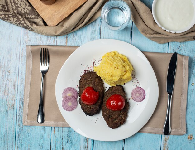 Casitas de carne con tomate a la parrilla y puré de papas