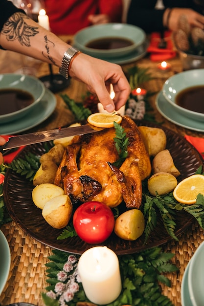 Foto gratuita cena de navidad con pavo y mano