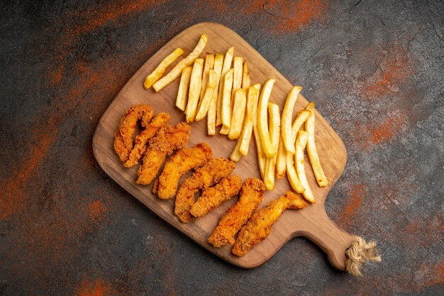 Cena sabrosa con pollo frito crujiente y patatas