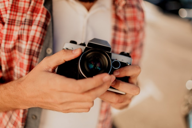 Centrarse en la cámara. Detalles Hombre sujetando la cámara de cine, haciendo fotos