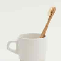 Foto gratuita cepillo de dientes de bambú natural en una taza
