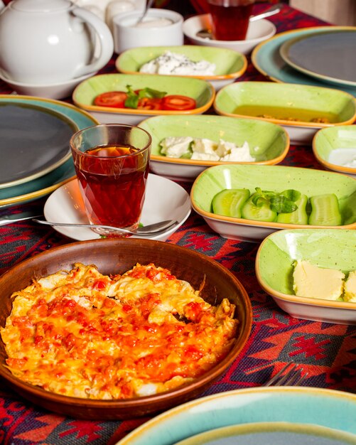 Cerca de huevo y tomate cocinado en aceite servido para el desayuno