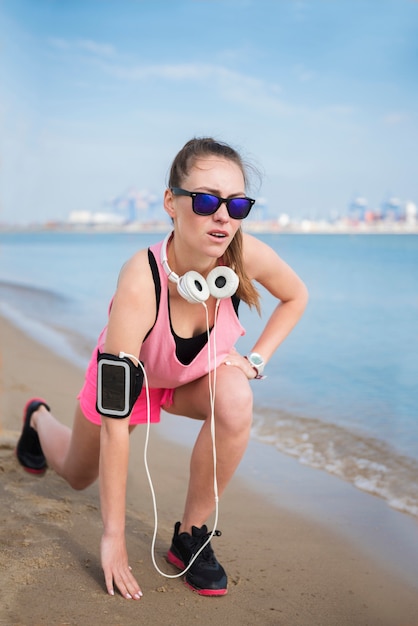 Cerca de la persona joven en forma de jogging por el mar