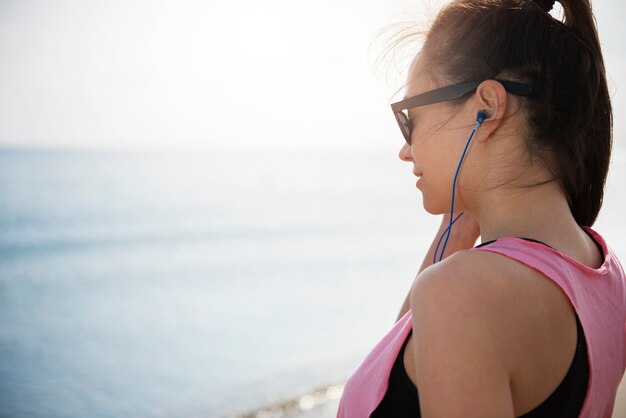 Cerca de la persona joven en forma de jogging por el mar