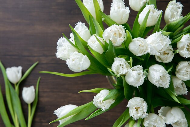 Cerca del ramo moderno de moda de diferentes flores sobre fondo de madera.