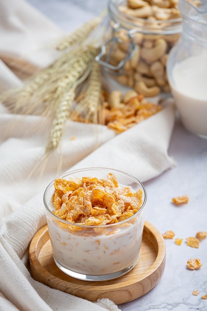 Cereal en un tazón y leche sobre fondo de mármol