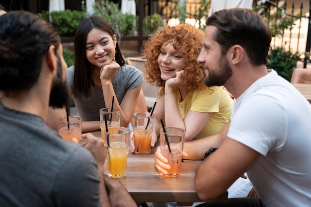 Foto gratuita cerrar amigos con bebidas en la mesa