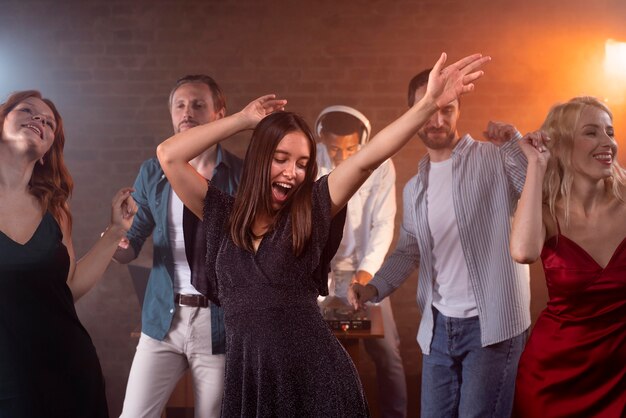 Cerrar amigos sonrientes bailando en el bar