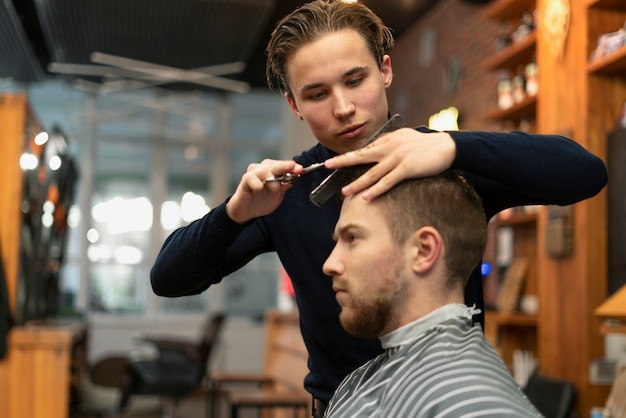 Cerrar hombre cortándose el pelo