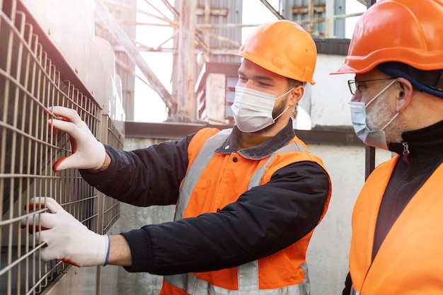 Cerrar hombres con máscaras trabajando juntos