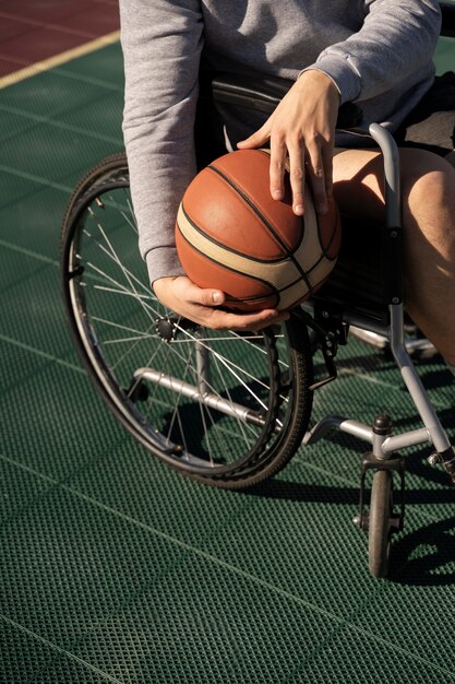 Cerrar las manos sosteniendo la pelota de baloncesto