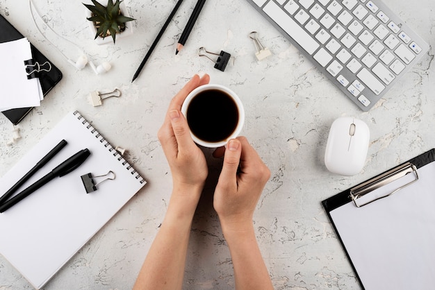 Foto gratuita cerrar las manos sosteniendo la taza de café