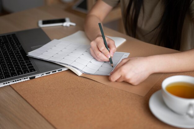 Cerrar mujer escribiendo con lápiz