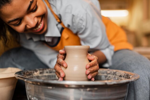 Cerrar mujer haciendo cerámica