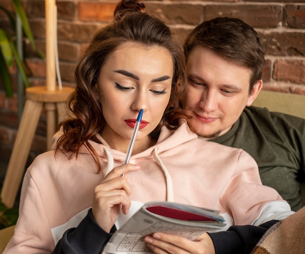 Cerrar pareja haciendo crucigrama