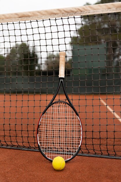 Cerrar en pelota de tenis y raqueta en el patio