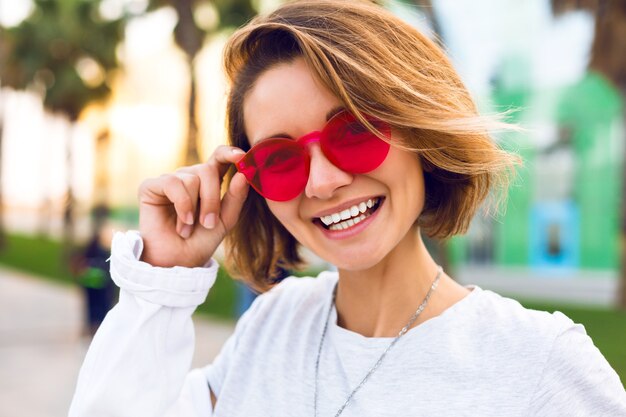 Cerrar retrato positivo de mujer joven alegre sonriendo y riendo, moda positiva