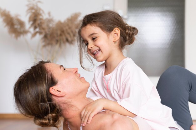 Cerrar sonriente mujer sosteniendo chica