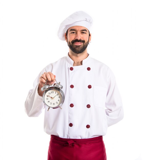 Chef de la celebración de un reloj sobre fondo blanco