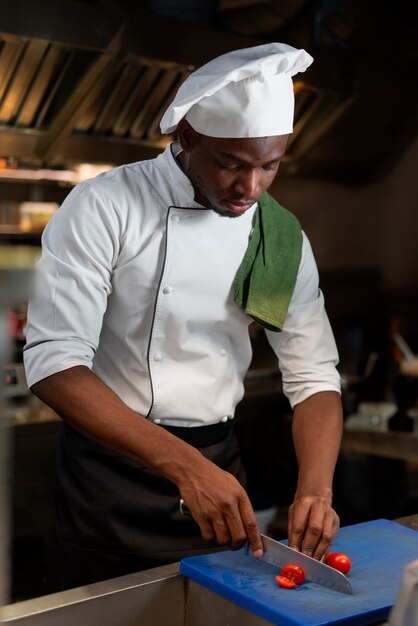 Chef cocinando en la cocina mientras lleva ropa profesional