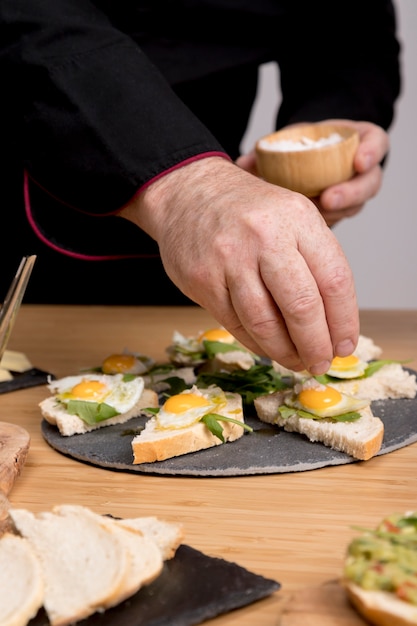 Chef condimento plato con huevos fritos