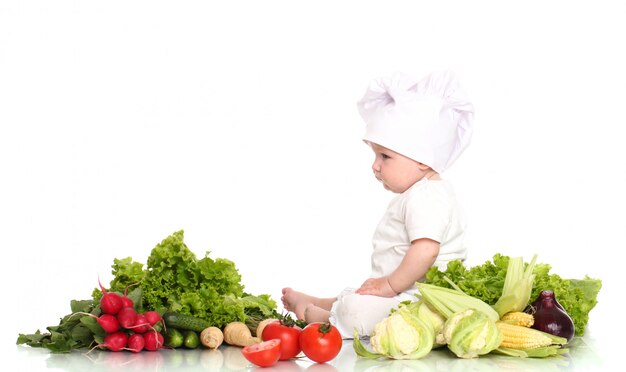 Chef lindo bebé con diferentes verduras