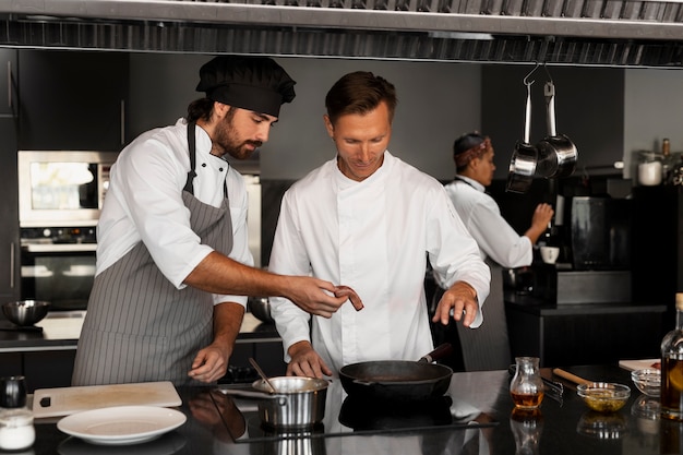 Foto gratuita chef trabajando juntos en una cocina profesional