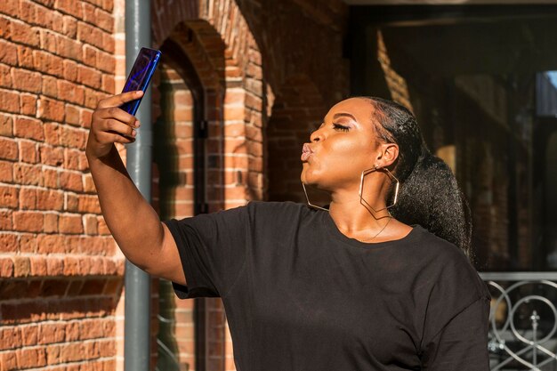 Chica adolescente de lado tomando un selfie