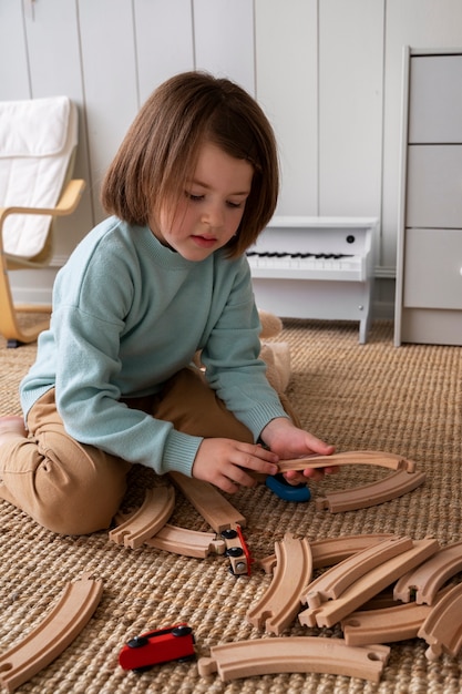 Chica de alto ángulo jugando con juguetes