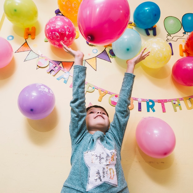 Chica arrojando globos