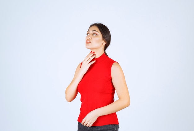 Chica en camisa roja dando poses neutrales, positivas y atractivas.